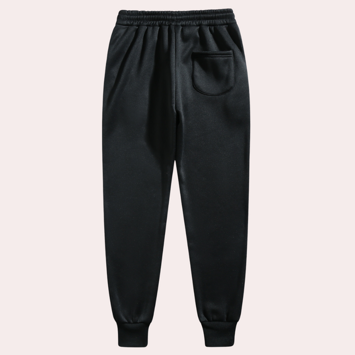 Mænds baggy joggingbukser i marineblå, forfra, med moderne og afslappet pasform.
