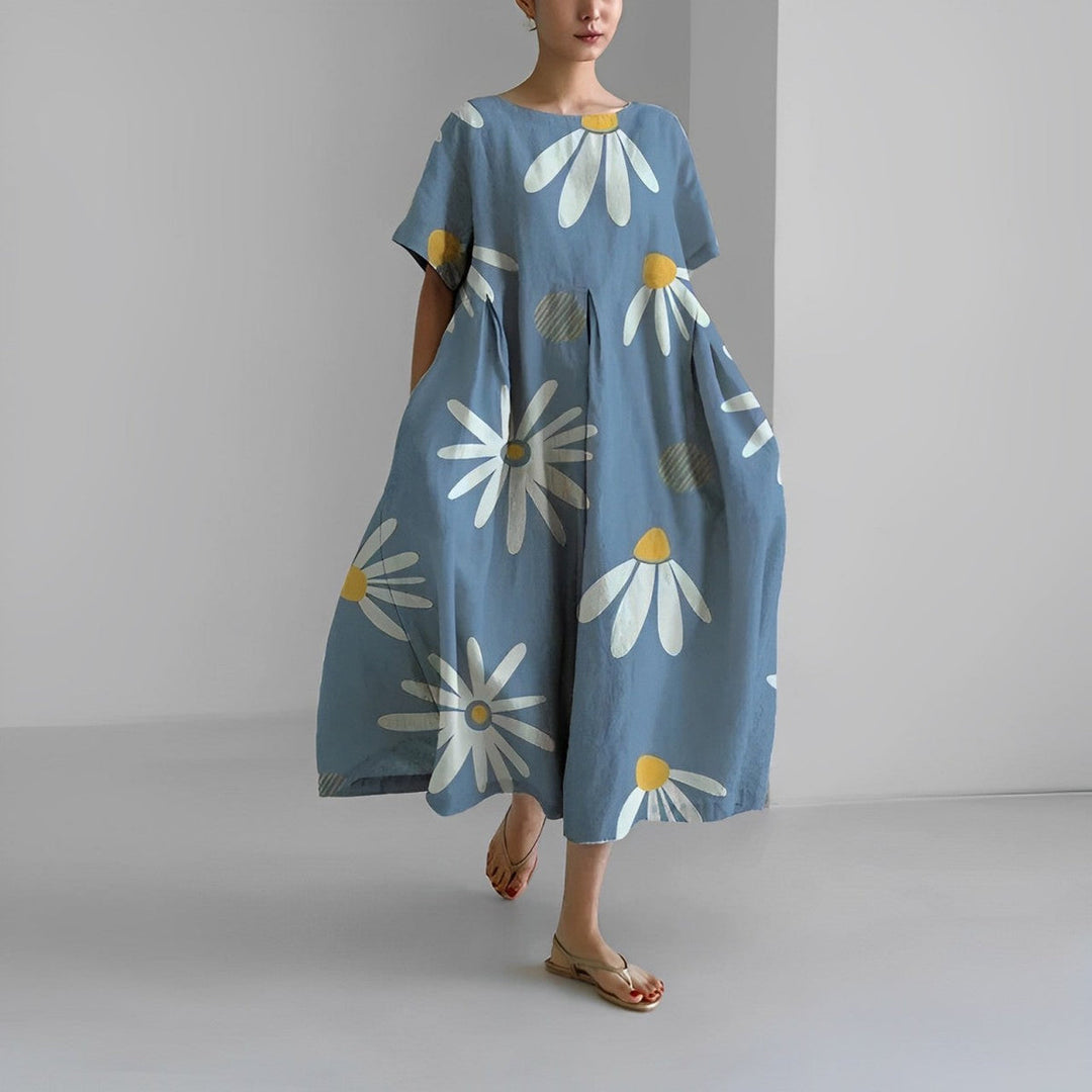 Boho blomstret kjole i fuld længde med løstsiddende pasform og delikat blomsterprint i varme farver.