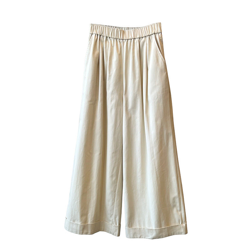 "Dame culotte-bukser med vide ben, elastisk talje og elegant folder, set forfra i lys beige farve."
