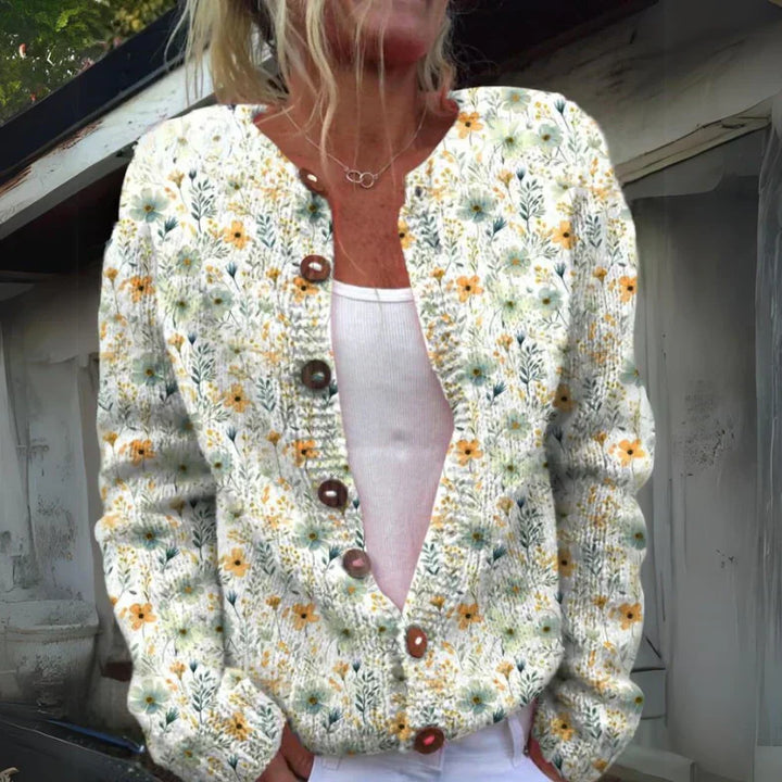 "Elegant blomstrede strikjakke til damer, front view, med farverige blomstermønstre, ideel til både arbejds- og fritidsbrug."