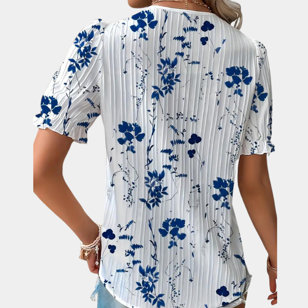 Elegant damebluse med blomstermønster og blondekant, perfekt til både hverdag og fest.