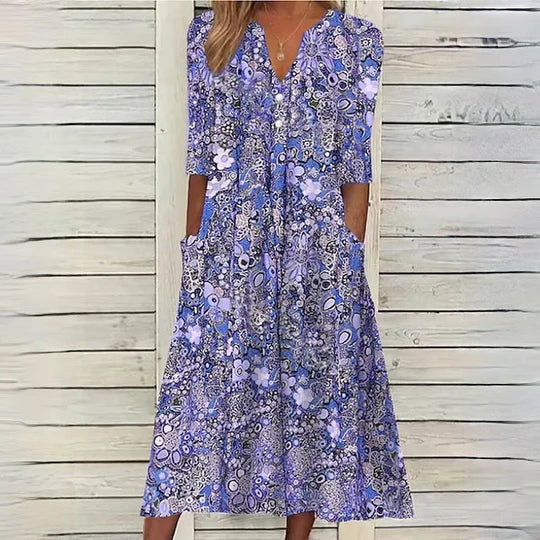 "Elegant blomstret midikjole, romantisk design med flatterende pasform, perfekt til specielle lejligheder."