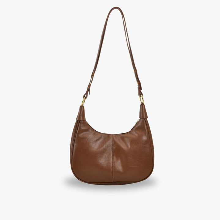 Elegant crossbodytaske med justerbar rem og guldfarvede detaljer, ideel til hverdagsbrug.