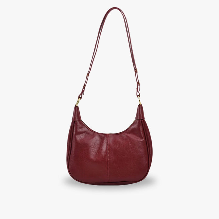 Elegant crossbodytaske med justerbar rem og guldfarvede detaljer, ideel til hverdagsbrug.