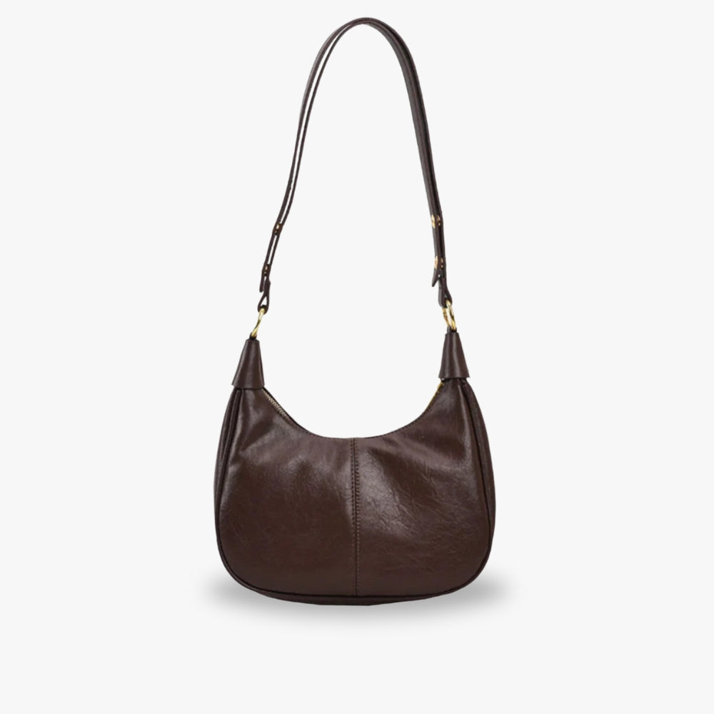 Elegant crossbodytaske med justerbar rem og guldfarvede detaljer, ideel til hverdagsbrug.