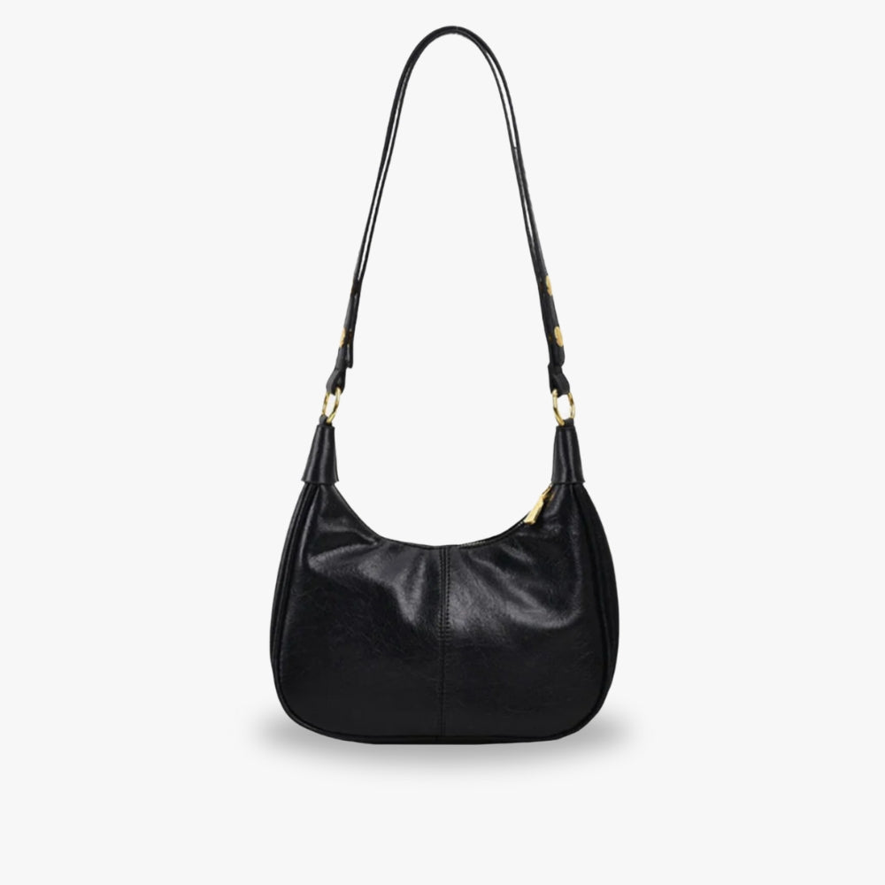 Elegant crossbodytaske med justerbar rem og guldfarvede detaljer, ideel til hverdagsbrug.