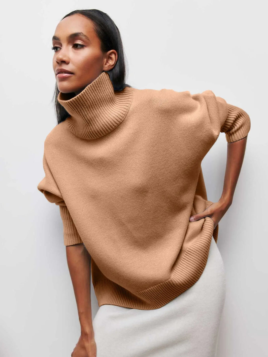 Nærbillede af den ribstrikkede tekstur på den varme og elegante dame striktrøje med høj hals.