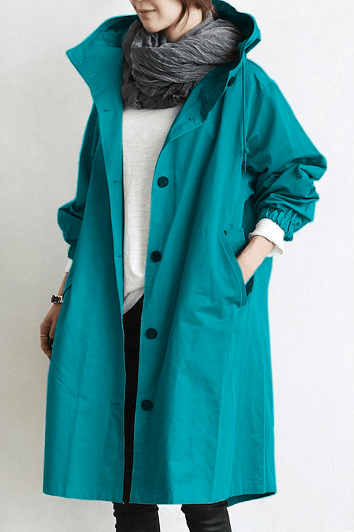 Beskyttende dame vandtæt trenchcoat. Hættejakke i stilrent design. Ideel forårsjakke og efterårsjakke mod regn.