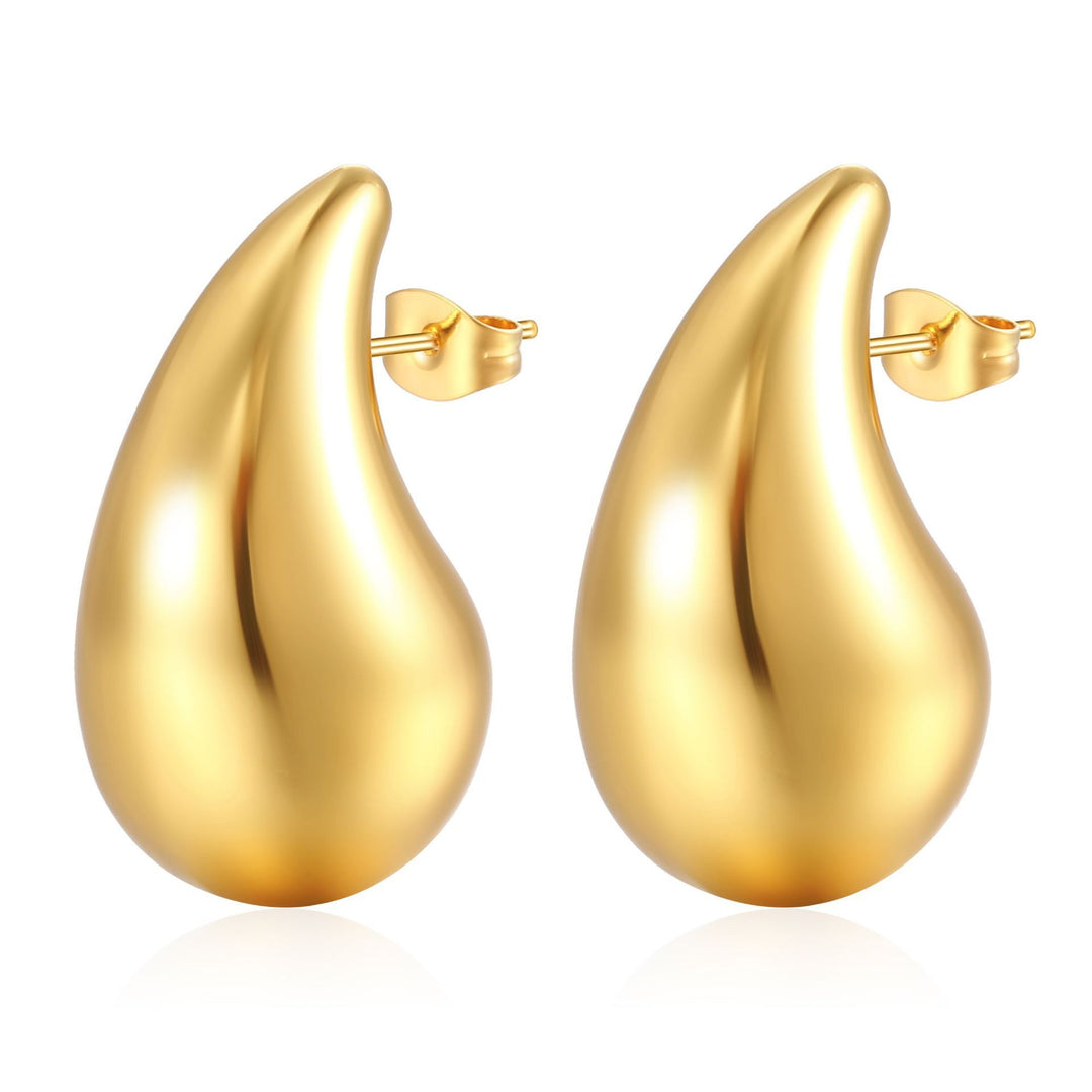 Elegant dråbeformede øreringe i sølv og guld, skinnende overflade, moderne skulpturelt design til kvinder