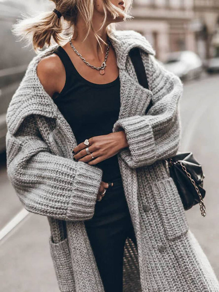 Oversized grå kvinde cardigan med reverskrave, designet for afslappet stil og komfort.