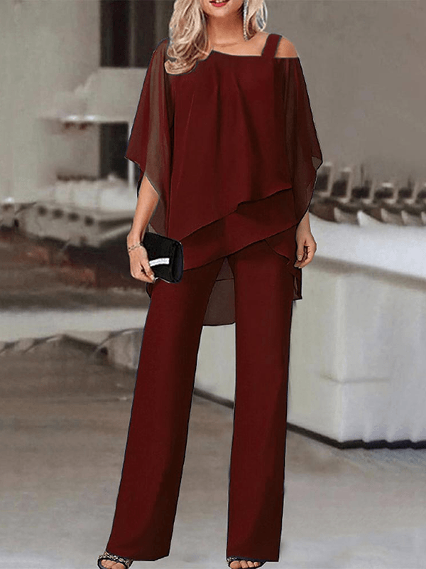 Trendy to-delt sæt til kvinder med asymmetrisk top og elegante vide bukser i brun. Perfekt til moderne festtøj.
