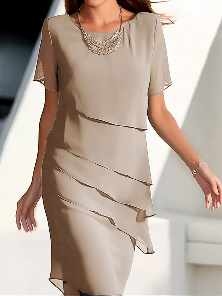 Elegant lagdelt chiffonkjole set forfra med bløde, flydende lag, ideel til hverdag og festlige anledninger.