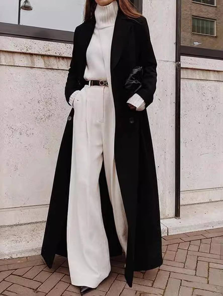 Elegant sort dame dobbeltradet ankellang frakke med revers. Perfekt til moderne kvinder som overtøj.
