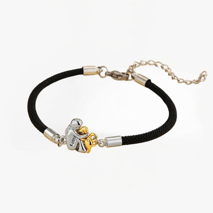 Elegant sort damearmbånd med gyldne charms. Moderne justerbart smykke til hverdag og fest.