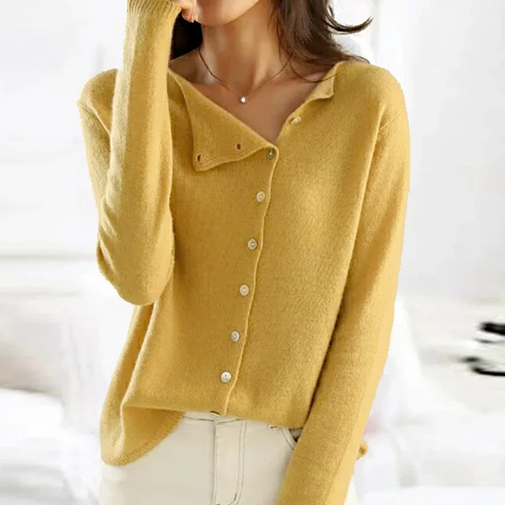 "Elegant strikbluse med knapper, rund hals og lange ærmer. Komfortabelt og tidløst design til hverdag og særlige lejligheder.