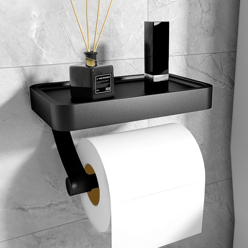 Elegant vægmonteret toiletpapirholder i sort aluminium med praktisk hylde til badeværelset, moderne design.