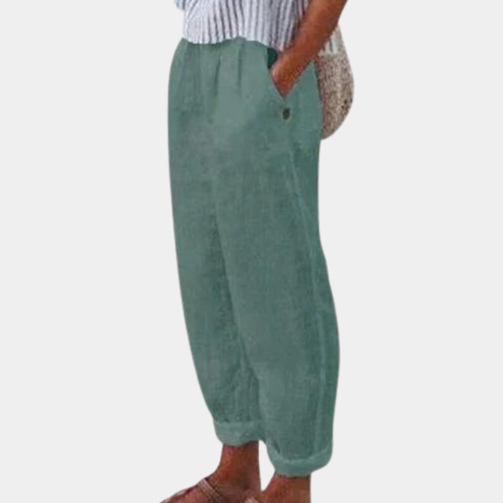 Elegante damebukser med høj talje, lige ben, elastisk linning og praktiske lommer, set forfra.