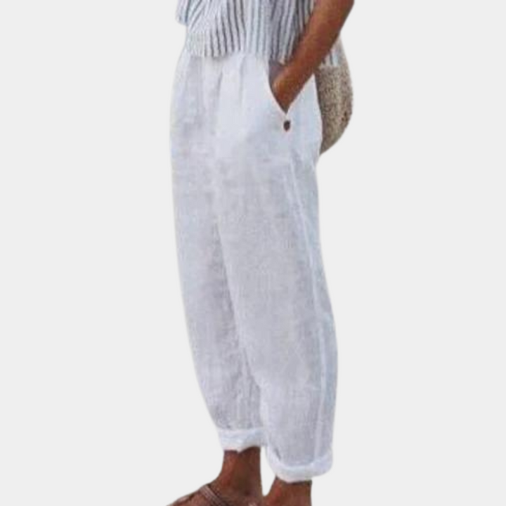 Elegante damebukser med høj talje, lige ben, elastisk linning og praktiske lommer, set forfra.