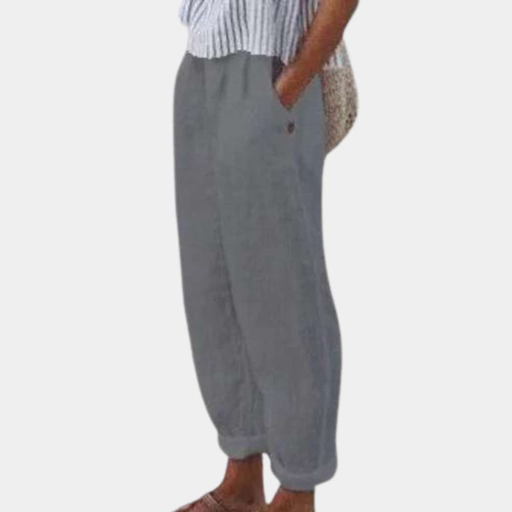 Elegante damebukser med høj talje, lige ben, elastisk linning og praktiske lommer, set forfra.