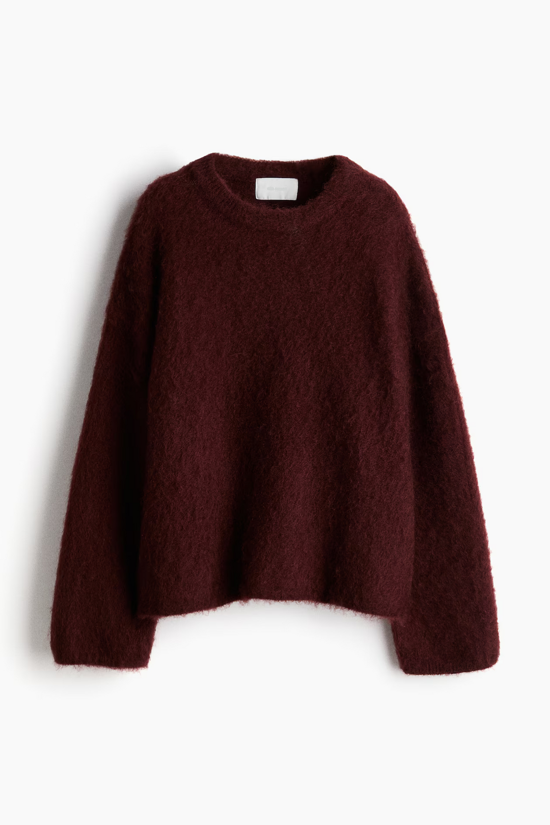 Elena trøje i cremehvid med rund hals, blød og varm, i en moderne oversized pasform perfekt til efteråret.