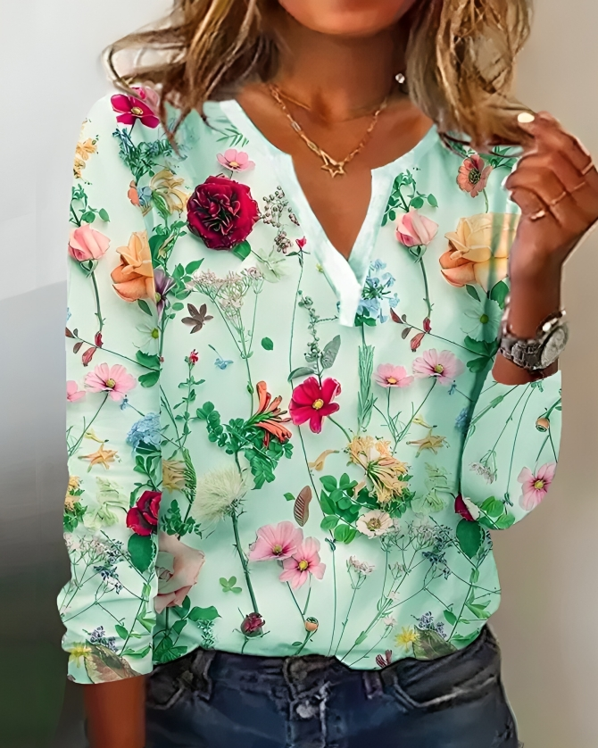 Elegant blomsterprint bluse til kvinder med V-udskæring. Lange ærmer og løs pasform gør den alsidig som festbluse.
