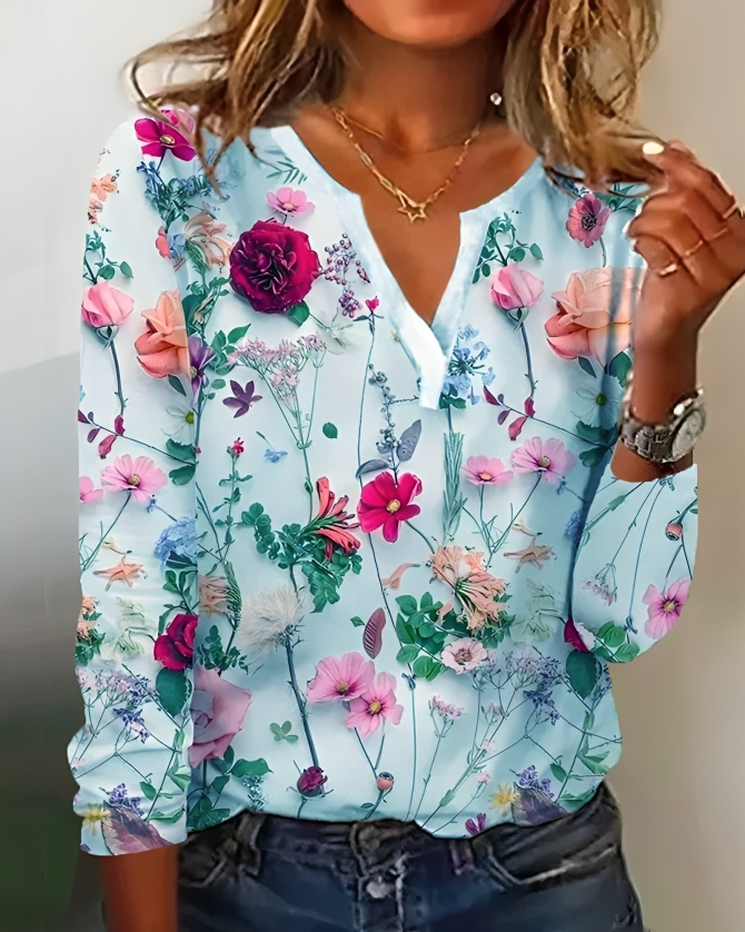 Stilfuld forårsbluse med blomsterprint, V-udskæring og lange ærmer. Komfortabel sommerbluse med feminin stil.
