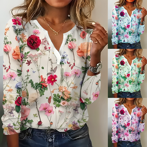 Detaljeret kvindebluse med farverigt blomsterprint, V-udskæring og lange ærmer. Perfekt til elegant eller casual look.
