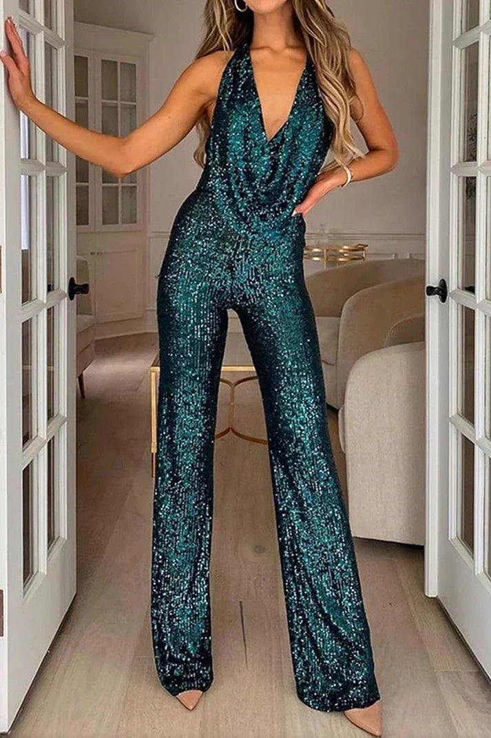 Dame festjumpsuit med skinnende pailletter og sofistikeret draperet halterneck. Perfekt til aften.