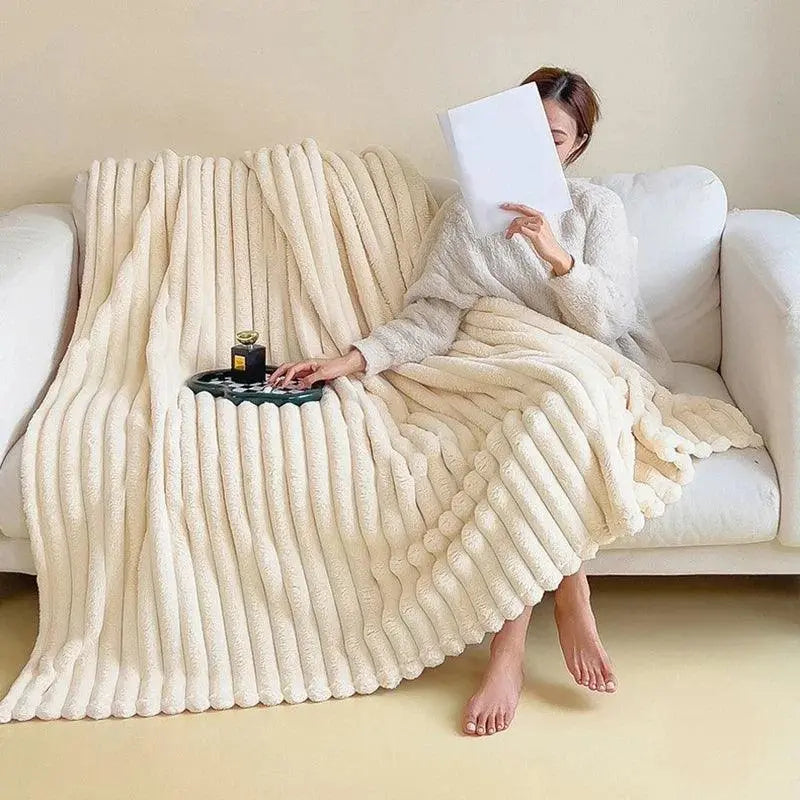 "Luksuriøst plysset fleece tæppe i blød beige. Perfekt til sofa eller seng for ekstra varme og hygge, fås i flere størrelser.