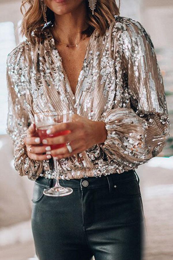 Dame glamourøs glittertop med V-hals, lange ærmer og gnistrende detaljer, ideel til fester og særlige anledninger.