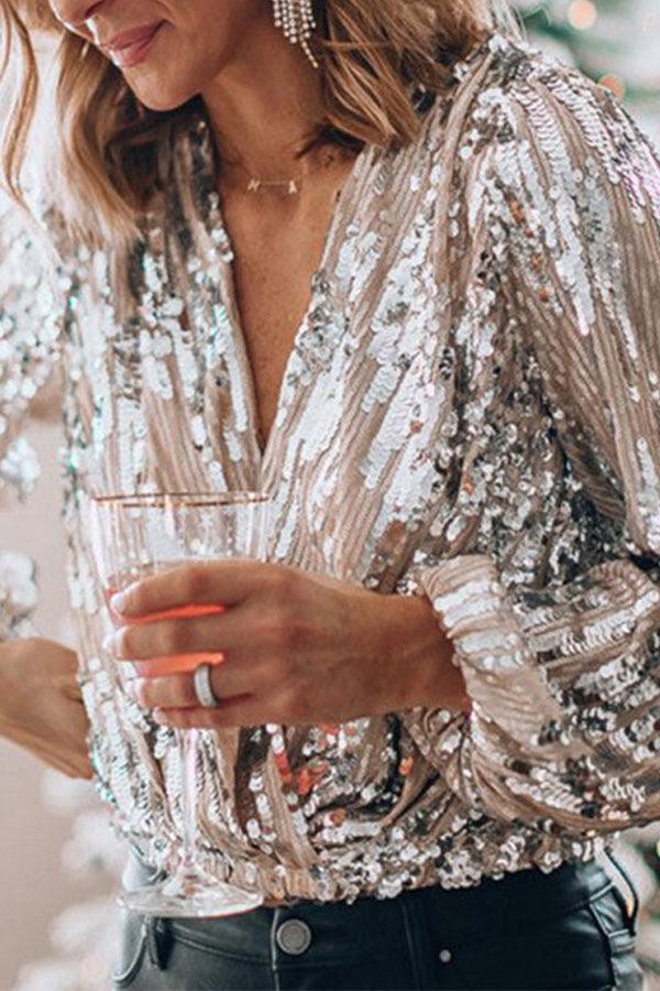 Dame glamourøs glittertop med V-hals, lange ærmer og gnistrende detaljer, ideel til fester og særlige anledninger.