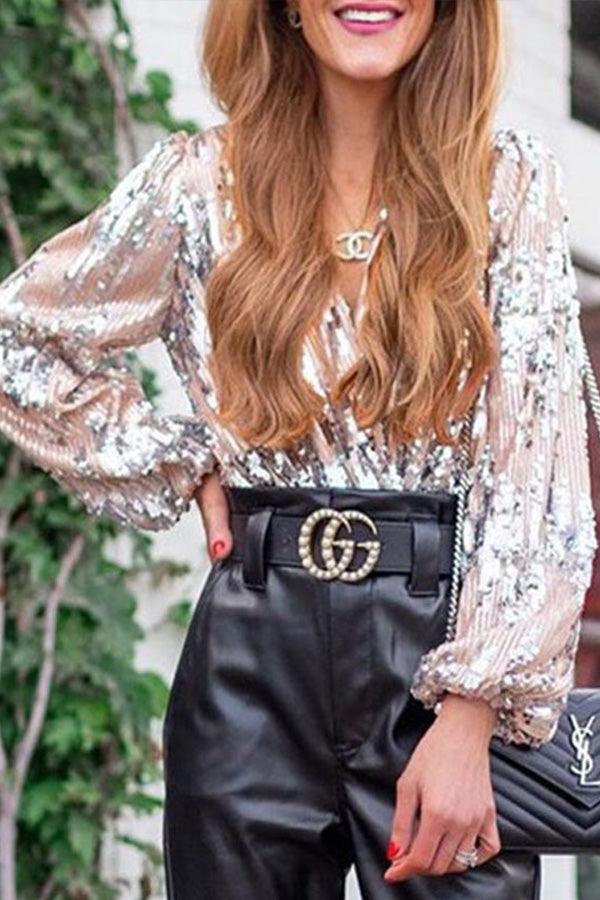 Dame glamourøs glittertop med V-hals, lange ærmer og gnistrende detaljer, ideel til fester og særlige anledninger.