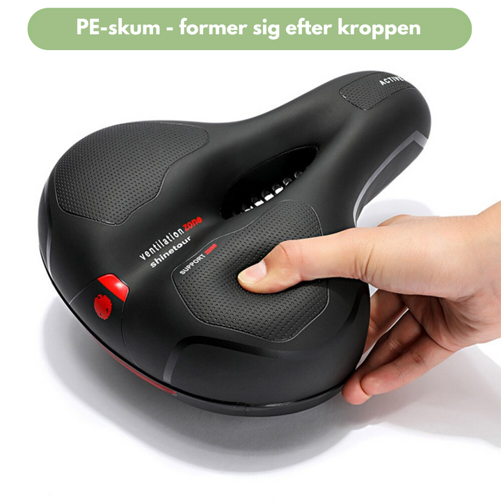 "Sort ergonomisk cykelsadel med hukommelsesskum og refleksstriber, ideel til lange cykelture for optimal komfort."