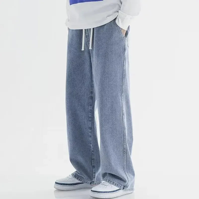 Grå unisex baggy jeans med elastisk talje. Afslappet fit og moderne look til streetwear.
