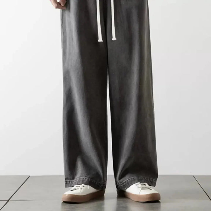 Mørkeblå unisex baggy jeans med elastisk talje. Tidløs streetwear mode med komfort.